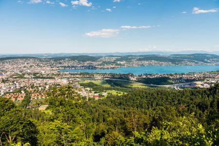 Panorama of  the of old downtown of Zurich city, with beautiful house at the bank of Lake of Zurich.  Aerial view from the the top of Mount Uetliberg  の写真素材