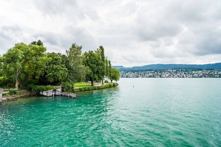 Beautiful lake Zurich landscape. Cloudy skyscape with  background of Alps mountains peaks.の写真素材