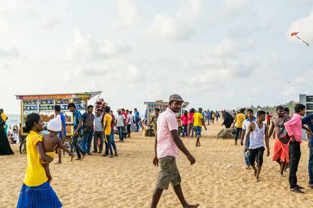 Local people relaxing at the Negombo beach in Sri Lanka on public holiday of the Vesak day.のeditorial素材