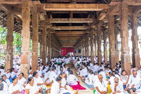 Buddhist pilgrims in the pavilions hall of shrine of Sri Dalada Maligawa or the Temple of the Sacred Tooth Relic, in Kandy, Sri Lanka, celebrating the  Vesak day, or Buddha Jayanti, Buddha Day.のeditorial素材