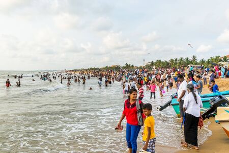 Local people relaxing at the Negombo beach in Sri Lanka on public holiday of the Vesak day.のeditorial素材