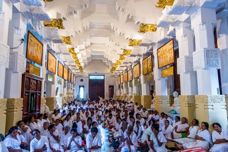 Buddhist pilgrims in the pavilions hall of shrine of Sri Dalada Maligawa or the Temple of the Sacred Tooth Relic, in Kandy, Sri Lanka, celebrating the Vesak day, or Buddha Jayanti, Buddha Day.のeditorial素材
