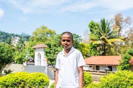 A Sri Lanka boy in the shrine of Sri Dalada Maligawa or the Temple of the Sacred Tooth Relic, in Kandy, Sri Lanka, celebrating the Vesak day, or Buddha Jayanti, Buddha Day.のeditorial素材