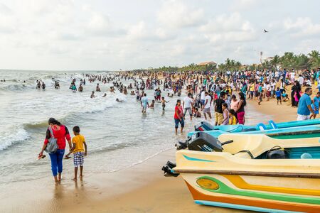 Local people relaxing at the Negombo beach in Sri Lanka on public holiday of the Vesak day.のeditorial素材