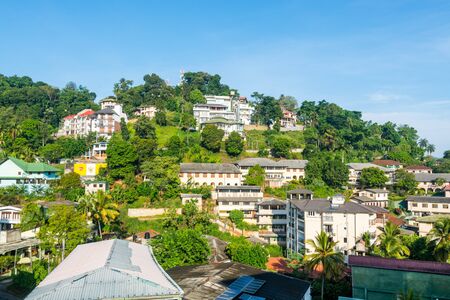 Beautiful builings on the green hills in the downtown, next to the Kandy Lake or Kiri Muhuda or the Sea of Milk, an artificial lake in the heart of the hill city of Kandy, Sri Lankaのeditorial素材