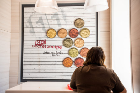 A woman eating food inside of KFC restaurant in Saint Petersburg, Russia
