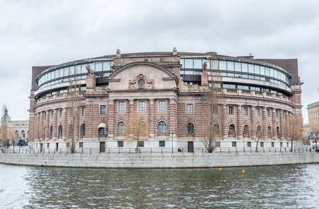 Riksdag (Parliament) Building at the bank of canal gainst cloudy sky in Stockholm, Sweden.のeditorial素材