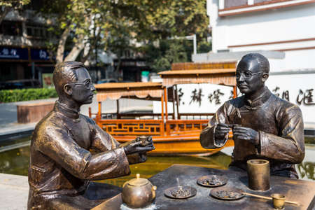 Statue of two Chinese young man drinking tea together on the bank of Qinhuai River, Nanjing, China.のeditorial素材