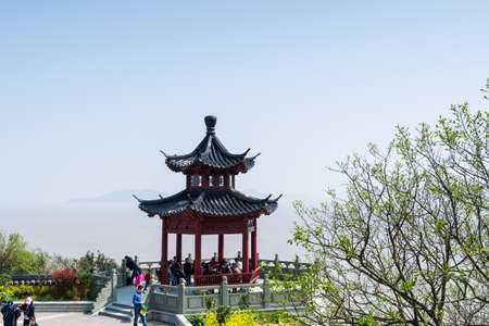 Tourists at the pavilion in Mount Luojia, which lies in the Lotus Sea to the southeast of Putuo Mountain, Zhoushan, Zhejiang, the place where Bodhisattva Guanyin practiced Buddhismのeditorial素材