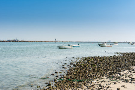 Fishing boat sailing at the sea in the corniche park, the city of Dammam, Kingdom of Saudi Arabia.のeditorial素材