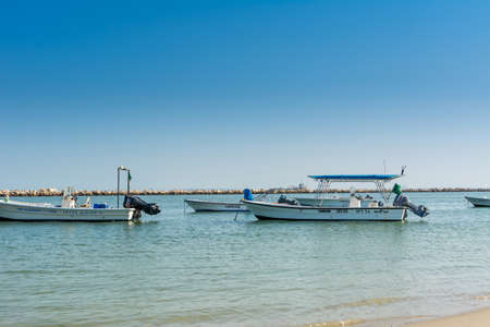 Fishing boat sailing at the sea in the corniche park, the city of Dammam, Kingdom of Saudi Arabia.のeditorial素材