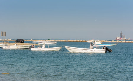 Fishing boat floating at the sea at the corniche park, Dammam, Saudi Arabiaのeditorial素材