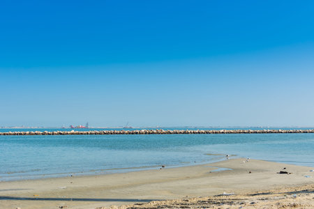 Blue sea and beach with blue sky at the corniche park in Dammam, Kingdom of Saudi Arabia