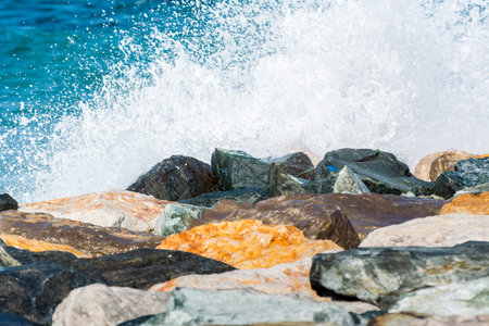 Waves of Persian Gulf splashing the stones of breakwater at the crescent road in the Palm Jumeirah island in Dubai of the United Arab Emirates.の写真素材