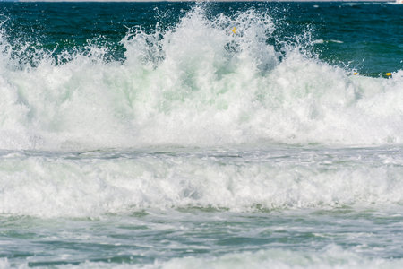 Waves, water splash flushing beach at Jumeirah beach at Persian gulf in Dubai, United Arab Emirates.