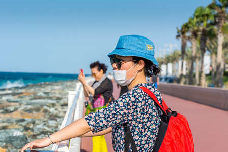 Tourists standing at the crescent road and looking at the sea in the Palm Jumeirah island in Dubai of the United Arab Emirates.のeditorial素材