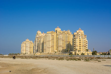 Tall residential buildings next to the beach against blue sky at Ras Al Khaimah, UAE