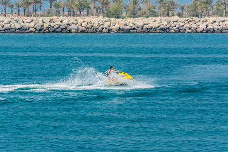 Tourist riding jet ski in the Persian bay in Abu Dhabi, United Arab Emiratesのeditorial素材