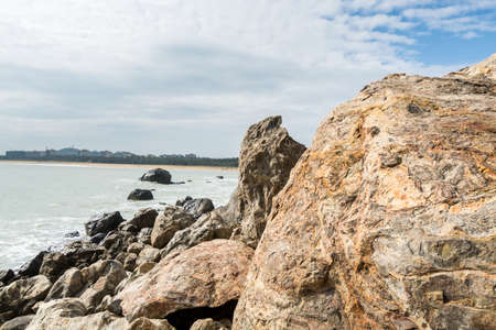 Seascape of waves splashing the stones in the rocky coastline of Yangxi, Yangjiang of Chinaの写真素材