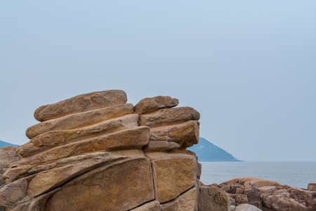 Rocks and beach in the Putuoshan, Zhoushan Islands, a renowned site in Chinese bodhimanda of the bodhisattva Avalokitesvara (Guanyin)の写真素材