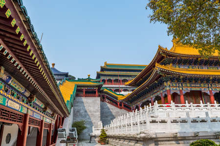 Architectural details of Chinese traditional royal style colorful Baoxiang lecture temples in the Putuoshan mountains, Zhoushan Islands, a renowned site in Chinese bodhimanda of the Guanyinの写真素材