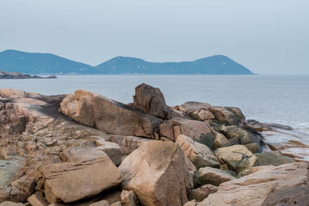Rocks and beach in the Putuoshan, Zhoushan Islands, a renowned site in Chinese bodhimanda of the bodhisattva Avalokitesvara (Guanyin)の写真素材