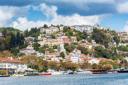 Modern buildings and ancient architecture along the Bosphorus strait in Istanbul Turkey from ferry on a sunny day with background of cloudy skyのeditorial素材