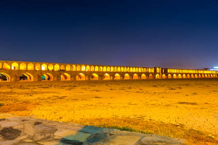 Arches of night view with light effect of Allahverdi Khan Bridge, also named Si-o-seh pol bridge across the Zayanderud river in Isfahan, Iran, a famous historic building in Persian Historyのeditorial素材
