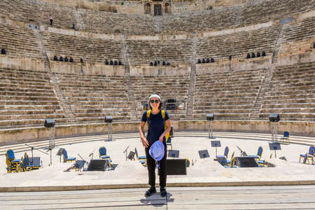 A female Chinese tourist in the ancient roman amphitheatre in Amman, Jordanのeditorial素材