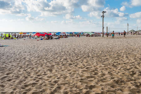 Lots of tourists spending their vacation and lots of umbrellas at the beach of Tel Aviv, Israel in summertime.のeditorial素材