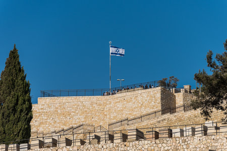 Israeli National flag waving on the view platform of Mount of Olive in Jerusalem, Israel
