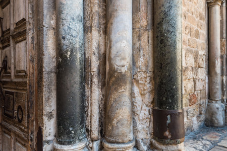 Old pillars of entrance to the Church (right side) of the Holy Sepulchre, also called the Church of the Resurrection or Church of the Anastasis, in Old City of Jerusalemの写真素材
