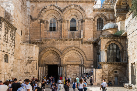 Lots of tourists and pilgrims at the square in front of the entrance to the Church of the Holy Sepulchre in Jerusalem, Israelのeditorial素材