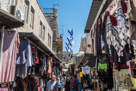 Street view with lots of tourist walking at the markets inside of old city of Jerusalem at the Temple Mount with background of Israeli National flags.のeditorial素材
