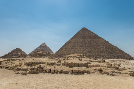 The Giza pyramid complex, an archaeological site on the Giza Plateau, on the outskirts of Cairo, Egypt. It includes the three Great Pyramids: Khufu Cheops, Khafre Chephren and Menkaure.の写真素材