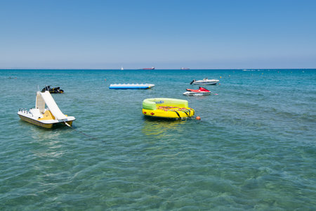 Rubber dinghy floating on the sea near the Larnaca Finikoudes beach of Cyprusのeditorial素材