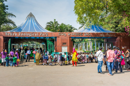 tourists and a group of Indian primary school pupils waiting for entering the Nehru Zoological park in Hyderabad City, Andhra Pradesh, Indiaのeditorial素材