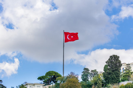 Turkish national flag and modern buildings along the Bosphorus strait in Istanbul Turkey from ferry...