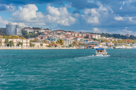 Cruise ship Sailing at Golden horn with ancient and modern buildings background in Istanbul Turkey from the Bosphorus strait on a sunny dayのeditorial素材