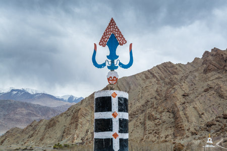 Tibetan traditional windmill and symbol of Hemis monastery with background of barren mountains in Leh, Ladakh, Indian Controlled Jammu and Kashmirの写真素材
