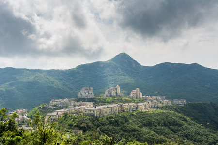 Modern castles on the top of mountain against cloudy sky in Overseas Chinese Town East (OCT East) in Shenzhen, Guangdong, China.の写真素材