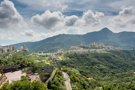 Modern castles on the top of mountain against cloudy sky in Overseas Chinese Town East (OCT East) in Shenzhen, Guangdong, China.の写真素材