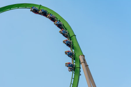 A group of people enjoy a fast roller coaster ride at the zhuhai Chimelong Ocean Kingdom Parkの写真素材