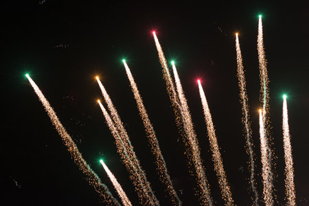 Background of fireworks exploding in the sky at night to celebrate holidayの写真素材