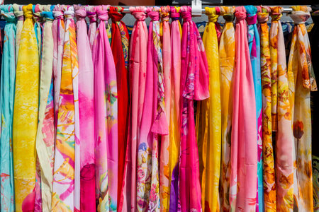 Colorful Silk scarves hanging in market for sale in the gift shops of New Yuanming Palace, Zhuhai, Chinaの写真素材
