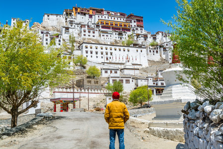 A male tourist standing in front of Thiksey Monastery or Thiksey Gompa, A famous Tibetan temple in Ladakh, Indiaのeditorial素材