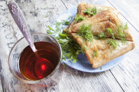 Some sandwiches on the blue plate. Near glass of tea. Horizontal.の写真素材