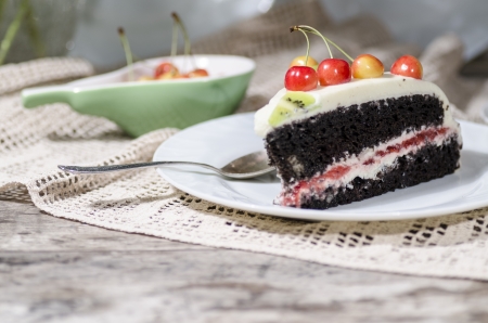 Bird-cherry flour cake with cherries, strawberries and kiwi. Homemade cake. From series "bird-cherry cake"の写真素材
