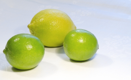 Lemons and limes on on white . From the series "Healthy Eating"の写真素材