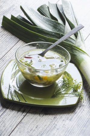 Vegetable soup in a glass bowl. Near onions and fresh herbs.. From series "Healthy Eating"の写真素材